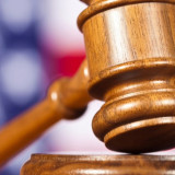 gavel with a flag in the background