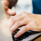 someone typing on a laptop