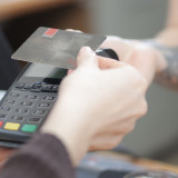 someone holding a card making a payment
