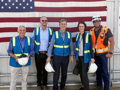 Rep. Stanton standing with others holding hardhats